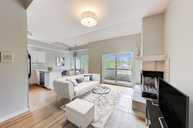 2136 W Evergreen Ave Unit 3B, Chicago, IL 60622 - living area featuring vaulted ceiling, light wood-style flooring, and a tile fireplace