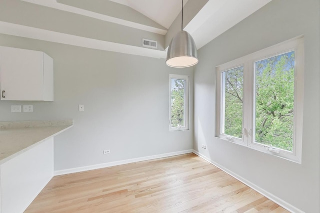 2136 W Evergreen Ave Unit 3B, Chicago, IL 60622 - unfurnished dining area featuring lofted ceiling, light wood-type flooring, and baseboards