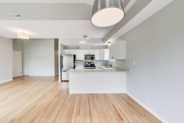 2136 W Evergreen Ave Unit 3B, Chicago, IL 60622 - kitchen featuring stainless steel appliances, light countertops, a sink, and light wood-type flooring