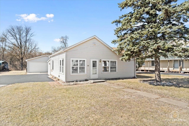 206 Walnut St, Cherry Valley, IL 61016 - view of front facade with an outdoor structure, a garage, and a front lawn
