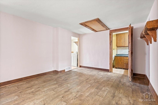 206 Walnut St, Cherry Valley, IL 61016 - empty room featuring wood finished floors, attic access, and baseboards