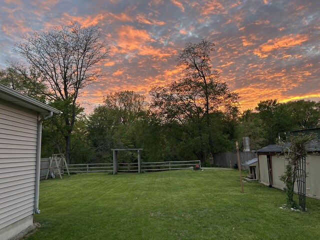 206 Walnut St, Cherry Valley, IL 61016 - yard at dusk with an outdoor structure