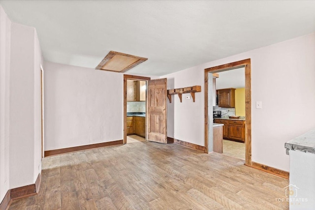 206 Walnut St, Cherry Valley, IL 61016 - unfurnished living room with light wood-style floors and baseboards