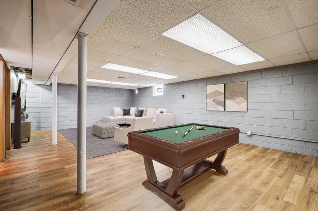 17708 Walter St, Lansing, IL 60438 - playroom with wood finished floors, concrete block wall, billiards, and a drop ceiling