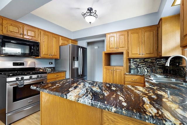 17708 Walter St, Lansing, IL 60438 - kitchen featuring stainless steel appliances, a sink, dark stone counters, and brown cabinetry