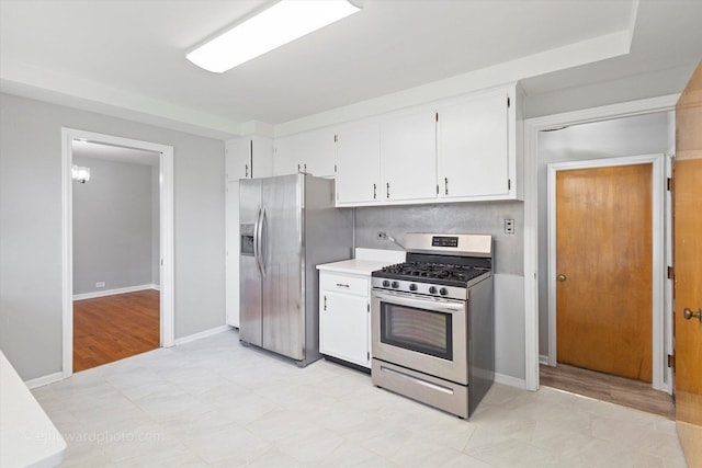 5049 Birchwood Ave, Skokie, IL 60077 - kitchen featuring appliances with stainless steel finishes, white cabinets, light countertops, and baseboards