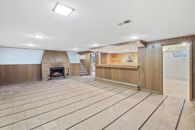 5049 Birchwood Ave, Skokie, IL 60077 - finished basement featuring wood walls, a brick fireplace, stairs, bar, and wainscoting