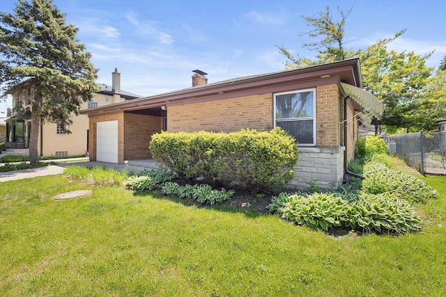 5049 Birchwood Ave, Skokie, IL 60077 - view of home's exterior with an attached garage, a chimney, brick siding, and driveway