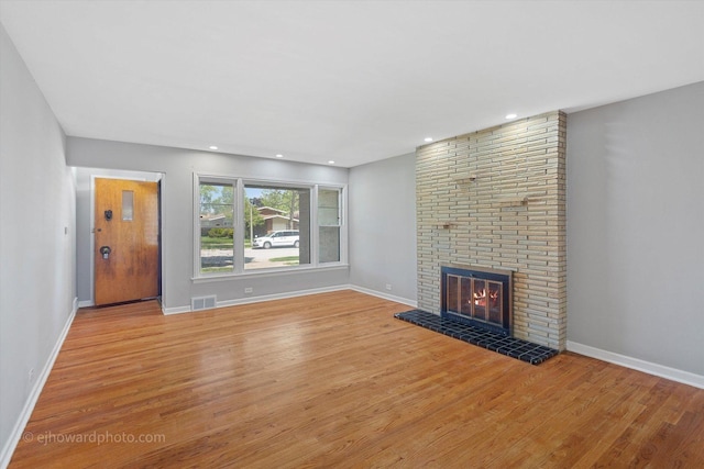 5049 Birchwood Ave, Skokie, IL 60077 - unfurnished living room with light wood-style floors, a fireplace, baseboards, and recessed lighting