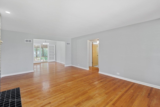 5049 Birchwood Ave, Skokie, IL 60077 - spare room featuring a chandelier, light wood-style floors, and baseboards