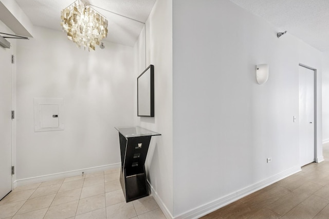 512 N Mcclurg Ct Unit 902, Chicago, IL 60611 - corridor featuring a chandelier, baseboards, and electric panel