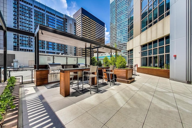 512 N Mcclurg Ct Unit 902, Chicago, IL 60611 - view of patio / terrace featuring exterior kitchen, a city view, a bar, and a grill