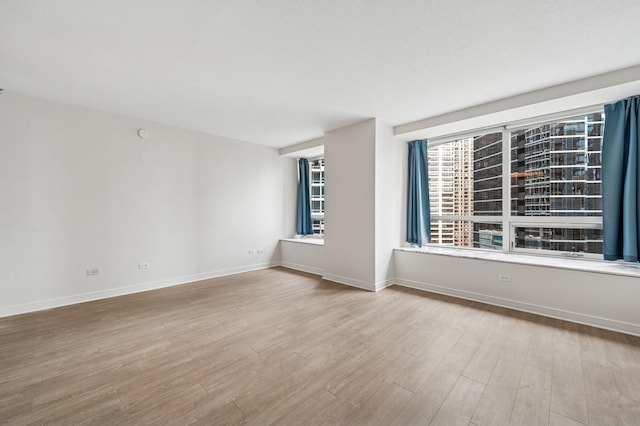 512 N Mcclurg Ct Unit 902, Chicago, IL 60611 - unfurnished room featuring wood finished floors and baseboards