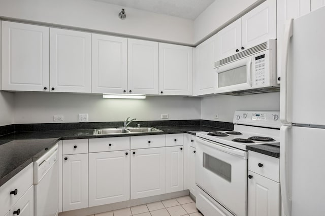 512 N Mcclurg Ct Unit 902, Chicago, IL 60611 - kitchen with white appliances, a sink, white cabinets, dark countertops, and light tile patterned floors
