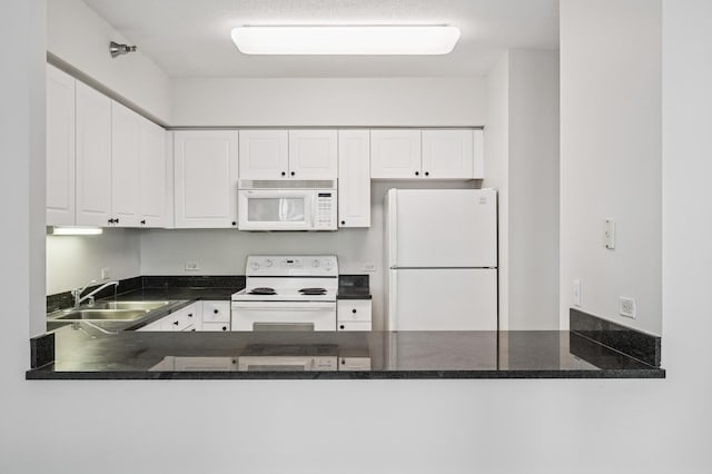 512 N Mcclurg Ct Unit 902, Chicago, IL 60611 - kitchen with white appliances, a peninsula, a sink, and white cabinetry
