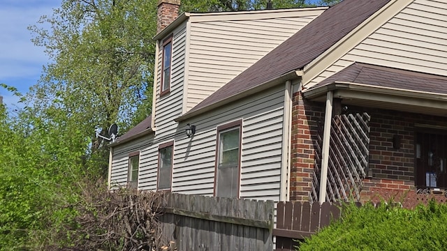 view of home's exterior featuring a chimney and brick siding
