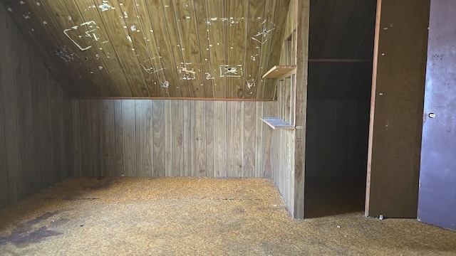 detailed view of carpet flooring, wood walls, and wooden ceiling