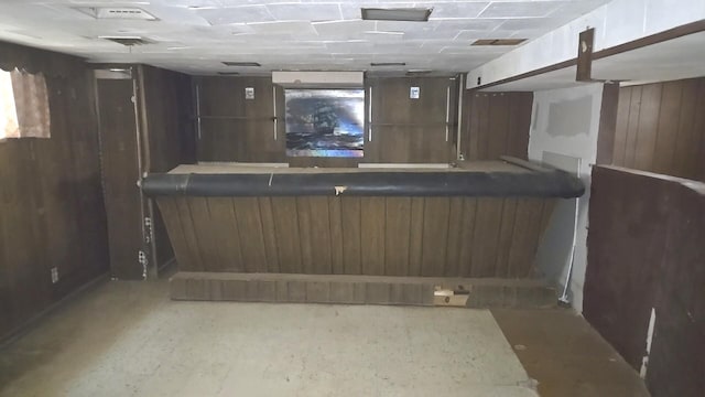 indoor dry bar featuring wooden walls