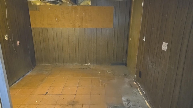 unfurnished room with wooden walls