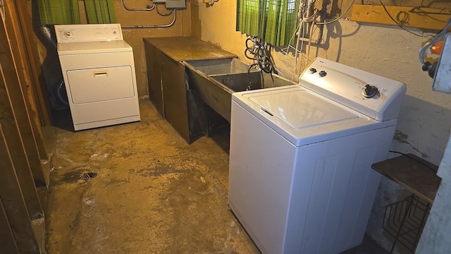 clothes washing area with separate washer and dryer
