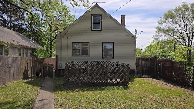 back of house featuring a chimney