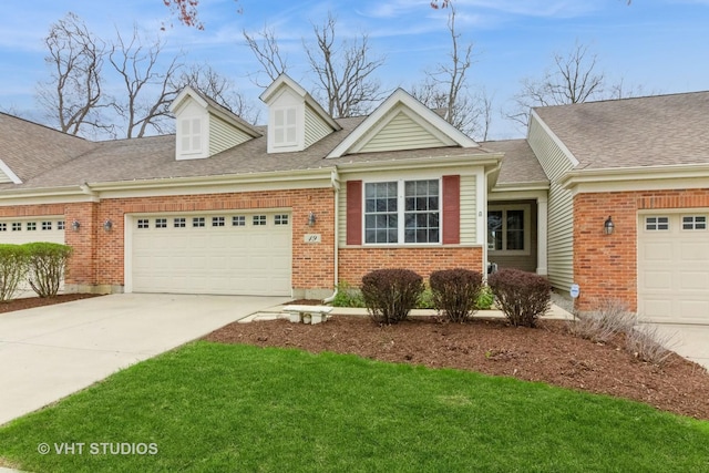 19 Tall Grass Ct, Streamwood, IL 60107 - view of front facade featuring a garage, concrete driveway, brick siding, and a front lawn