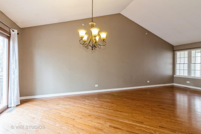 19 Tall Grass Ct, Streamwood, IL 60107 - unfurnished room featuring vaulted ceiling, light wood-type flooring, a chandelier, and healthy amount of natural light