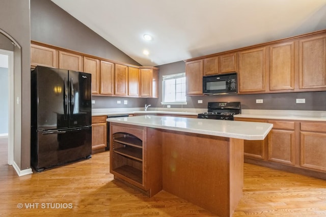 19 Tall Grass Ct, Streamwood, IL 60107 - kitchen featuring black appliances, light wood-type flooring, lofted ceiling, a center island, and light countertops