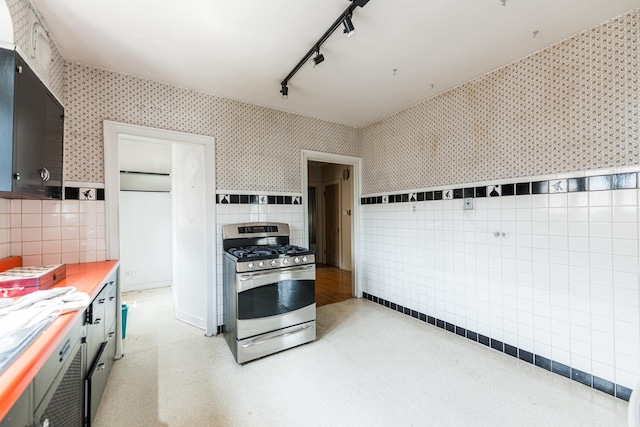 1753 N Normandy Ave, Chicago, IL 60707 - kitchen featuring gas range, tile walls, track lighting, wallpapered walls, and light countertops