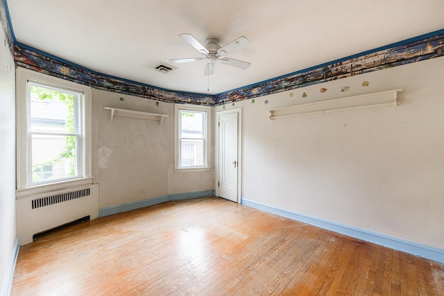 1753 N Normandy Ave, Chicago, IL 60707 - empty room featuring radiator, light wood-style floors, baseboards, and a ceiling fan