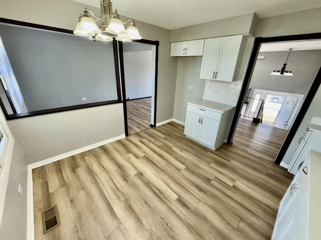 20084 Brook Ave, Lynwood, IL 60411 - unfurnished dining area featuring a chandelier, light wood finished floors, and baseboards