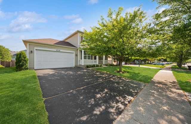 2739 Moraine Valley Rd, Wauconda, IL 60084 - obstructed view of property featuring an attached garage, asphalt driveway, and a porch