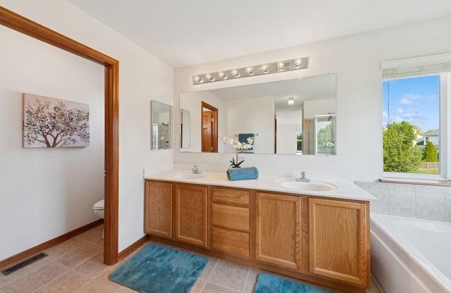 2739 Moraine Valley Rd, Wauconda, IL 60084 - bathroom with toilet, a bath, double vanity, tile patterned floors, and baseboards