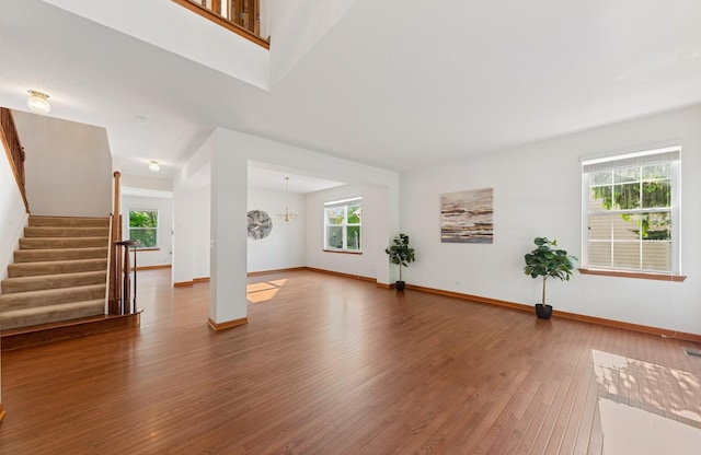 2739 Moraine Valley Rd, Wauconda, IL 60084 - unfurnished living room with healthy amount of natural light, hardwood / wood-style flooring, stairs, and baseboards