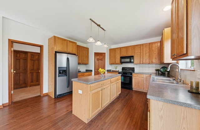 2739 Moraine Valley Rd, Wauconda, IL 60084 - kitchen featuring black appliances, a sink, a kitchen island, dark countertops, and dark wood-style flooring