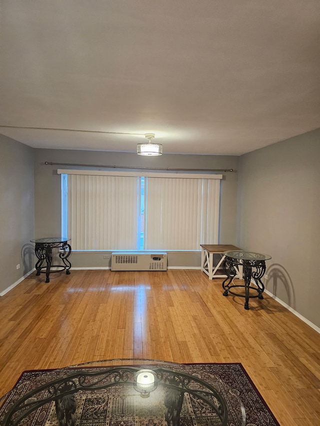 606 Green Bay Rd Unit 2A, Glencoe, IL 60022 - empty room featuring radiator, wood finished floors, and baseboards
