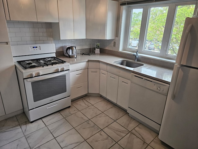 606 Green Bay Rd Unit 2A, Glencoe, IL 60022 - kitchen featuring white appliances, a sink, light marble finish floors, and white cabinetry