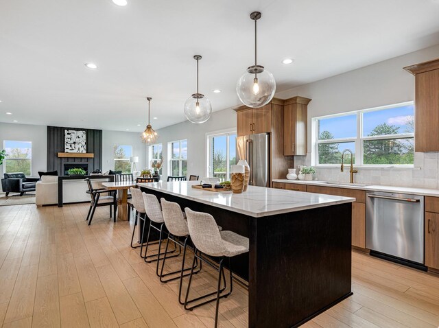 12744 Caruso Ct, Lemont, IL 60439 - kitchen with stainless steel appliances, a sink, a center island, plenty of natural light, and recessed lighting