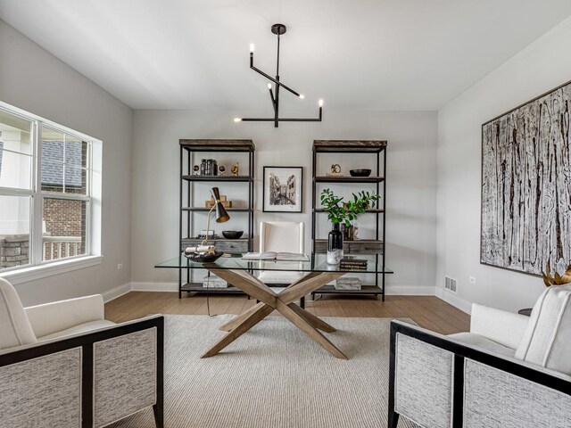 12744 Caruso Ct, Lemont, IL 60439 - home office with wood finished floors, baseboards, and a chandelier