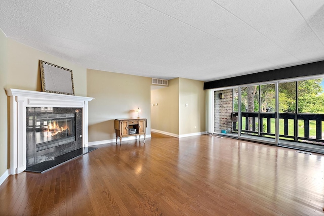 13151 S Westview Dr Unit 1B, Palos Heights, IL 60463 - unfurnished living room with a tile fireplace, wood finished floors, baseboards, and a textured ceiling