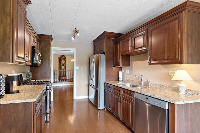13151 S Westview Dr Unit 1B, Palos Heights, IL 60463 - kitchen featuring appliances with stainless steel finishes, a sink, wood finished floors, a textured ceiling, and light stone counters