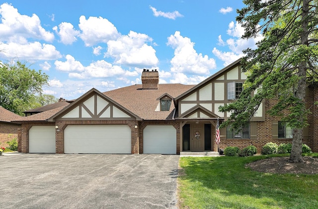 13151 S Westview Dr Unit 1B, Palos Heights, IL 60463 - tudor home with driveway, a garage, brick siding, and a front lawn
