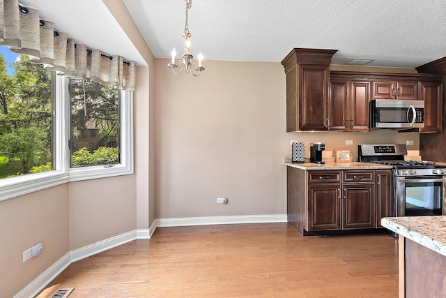 13151 S Westview Dr Unit 1B, Palos Heights, IL 60463 - kitchen featuring appliances with stainless steel finishes, light wood-style flooring, a chandelier, and dark brown cabinets