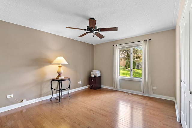13151 S Westview Dr Unit 1B, Palos Heights, IL 60463 - empty room with wood finished floors, ceiling fan, baseboards, and a textured ceiling