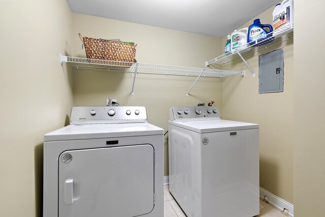 13151 S Westview Dr Unit 1B, Palos Heights, IL 60463 - laundry area with electric panel, washer and dryer, light tile patterned floors, and baseboards