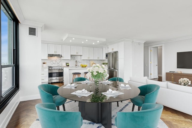 1030 N State St Unit 42L, Chicago, IL 60610 - dining area with plenty of natural light, ornamental molding, recessed lighting, baseboards, and a raised ceiling