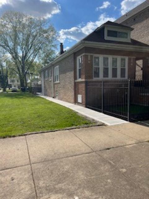 view of side of home featuring brick siding