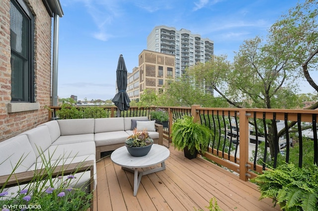 wooden terrace with an outdoor living space