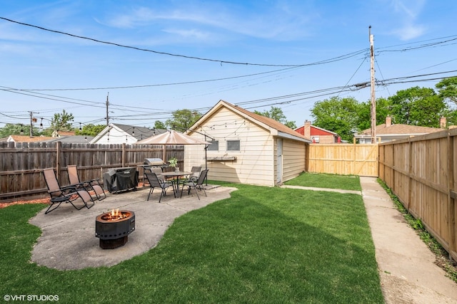 view of yard with a fire pit, a patio, and an outdoor structure