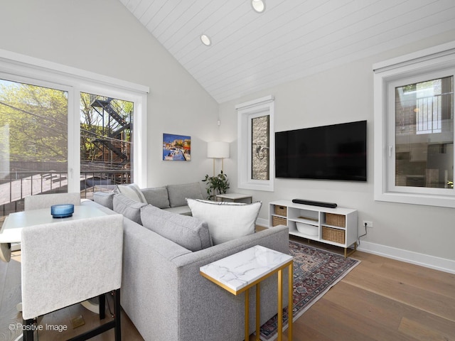 living room with wood finished floors, baseboards, recessed lighting, and high vaulted ceiling